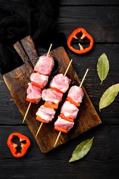 Raw shish kebab. Barbecue Meat Spices and Herbs, top view flat lay, on black wooden table background