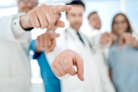 Doctors pointing with the index finger at the viewer.