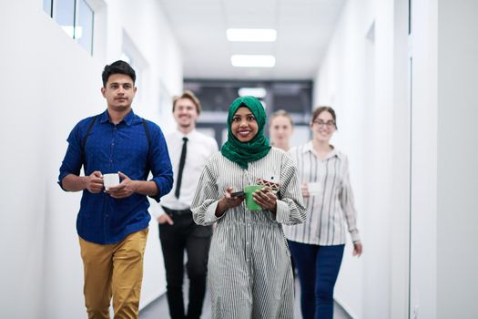 multi-ethnic startup business team walking through the hallway