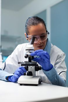 Biologist woman working at vaccine development analyzing blood sample