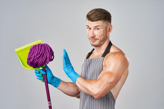 pumped up cleaner in aprons with a mop in the hands of providing services