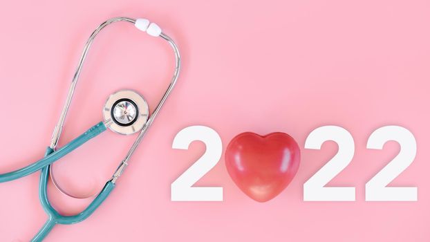 Medical Checkup and Health Insurance on Year 2022 Concept, Stethoscope With Text New Year 2022 on Isolate Pink Background. Doctor Appointment Calendar for Medical Examination Annual 2022. Medical Care