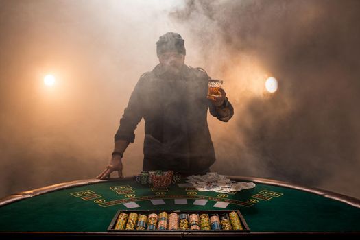 Male gambler playing poker, smoke dark color intensity.