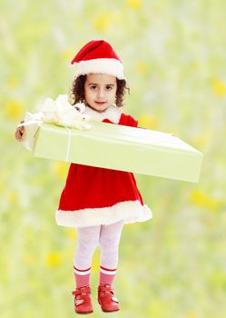 Little girl in costume of Santa Claus with gift
