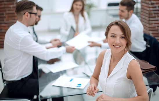 smiling business woman sitting in front of Desk