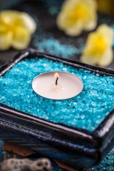 Spa background, candle in a bowl with salt baths 