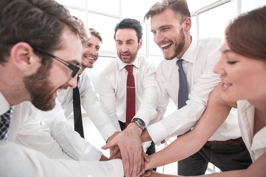 happy business team connects their hands together