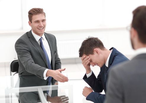 investor holding the hand of frustrated businessman