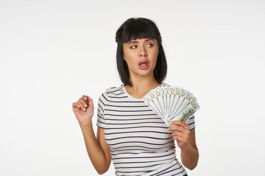 woman in a striped t-shirt wearing glasses with money in hands wealth finance