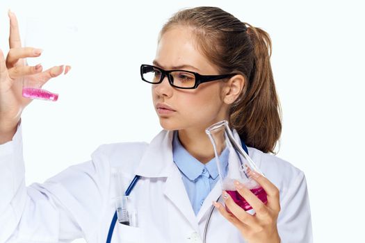 female laboratory assistant in white coat chemical solution analyzes research