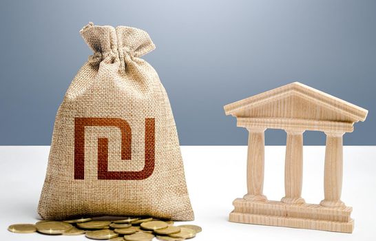 Israeli shekel money bag and bank / government building. Budgeting, national financial system. Support businesses in crisis. Lending loans, deposits. Monetary policy. Resource allocation.
