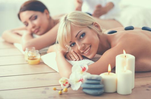 Two young beautiful women relaxing and enjoying at the spa cent