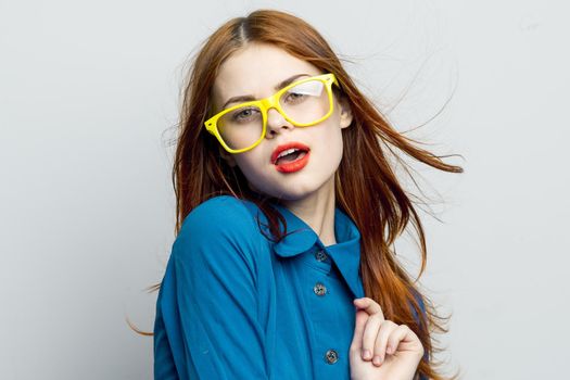 woman in blue shirt yellow glasses charm glamor