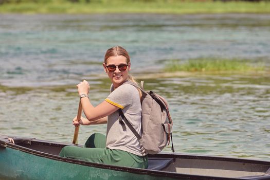 woman adventurous explorer are canoeing in a wild river
