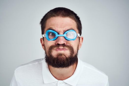 man in goggles for swimming in a white shirt emotions close-up