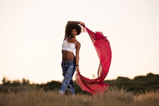 black girl dances outdoors in a meadow