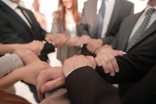 background image of business team folded their hands forming a circle