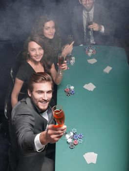 group of friends sitting at a casino table