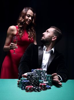 woman and man at the poker table with chips and drinks