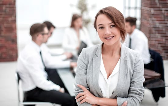 portrait of young business woman on blurred office background