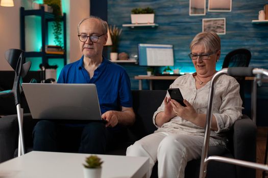 Married couple enjoying retirement with technology at home