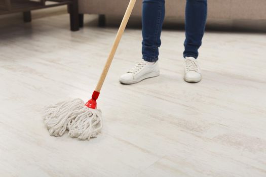 Unrecognizable woman with mop ready to clean floor
