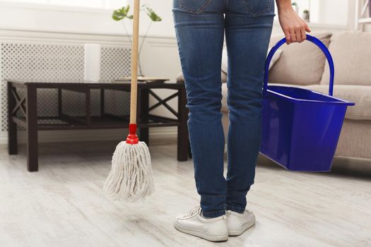 Unrecognizable woman with mop ready to clean floor