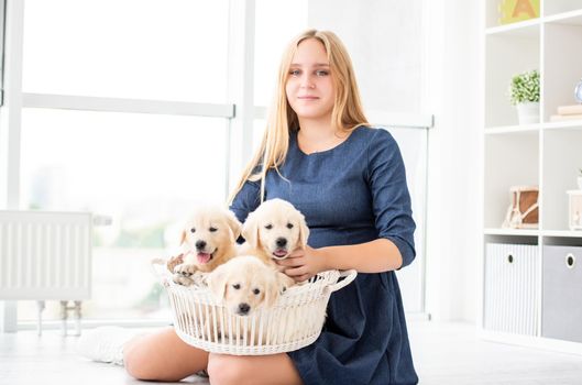 Happy girl holding puppies