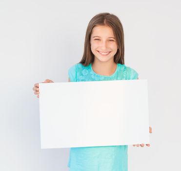 Teen girl holding sheet of paper