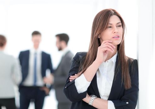 pensive business woman on blurred office background