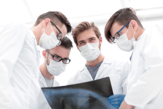 male doctors looking attentively at x-ray
