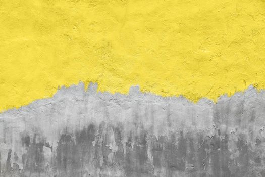 Weathered yellow painted gray concrete wall