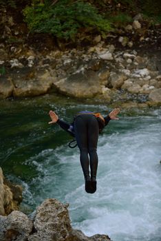 Man jumping in wild river