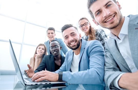 Happy smiling multi-ethnic creative millennial team excited by online result or growth
