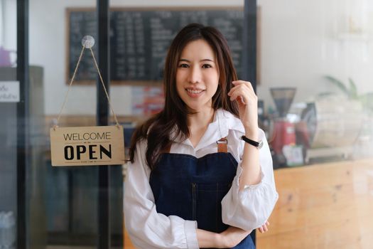 Asian coffee shop owner in coffee shop. Small business owner and startup in coffee shop concept.