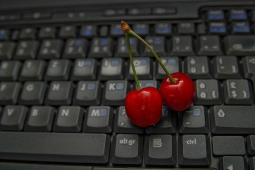 fresh cherry on laptop keyboard 