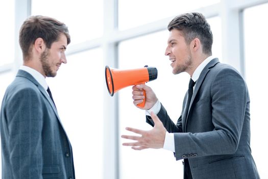 aggressive businessman with megaphone screaming on his coworker, isolated on white