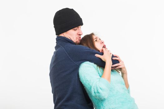 Woman victim of violence and abuse. Criminal man beats a woman on white background