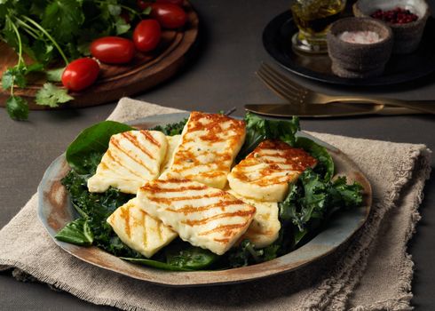 Cyprus fried halloumi cheese with healthy green salad. Lchf, pegan, fodmap, paleo, scd, keto diet.