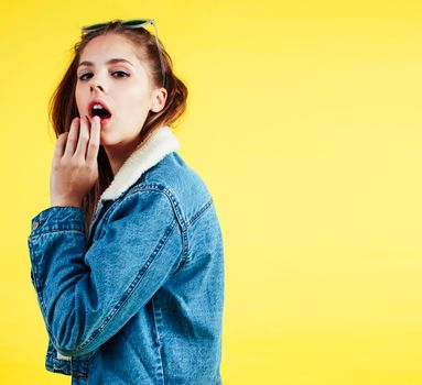 lifestyle people concept: pretty young school teenage girl having fun happy smiling on yellow background close up
