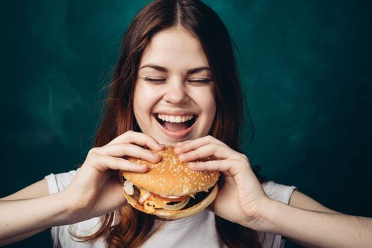 cheerful woman eating hamburger snack close-up lifestyle