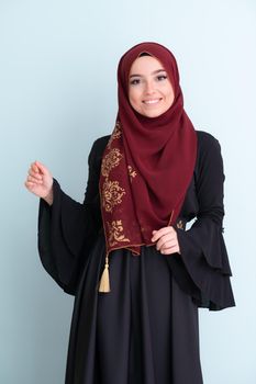 muslim woman with hijab on cyan backgrund