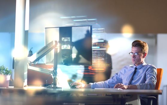 man working on computer in dark office