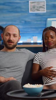 Pregnant interracial couple using video call conference