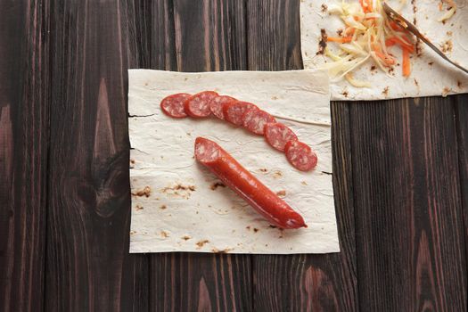 smoked salami with pita bread on wooden background