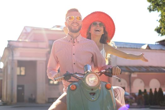 Young beautiful couple riding on motorbike. Adventure and vacations concept.
