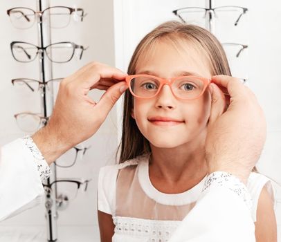 Little girl choosing glasses