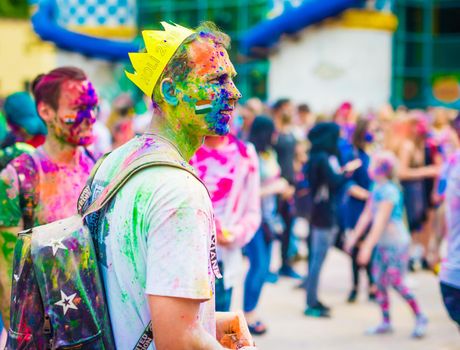 People sprinkle colorful paints during celebrating holi fest