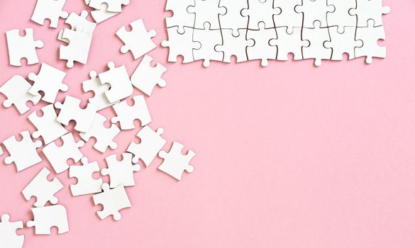 Puzzle pieces on pink background