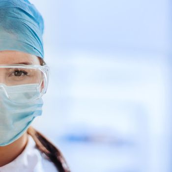portrait of a female medical scientist in a protective mask.